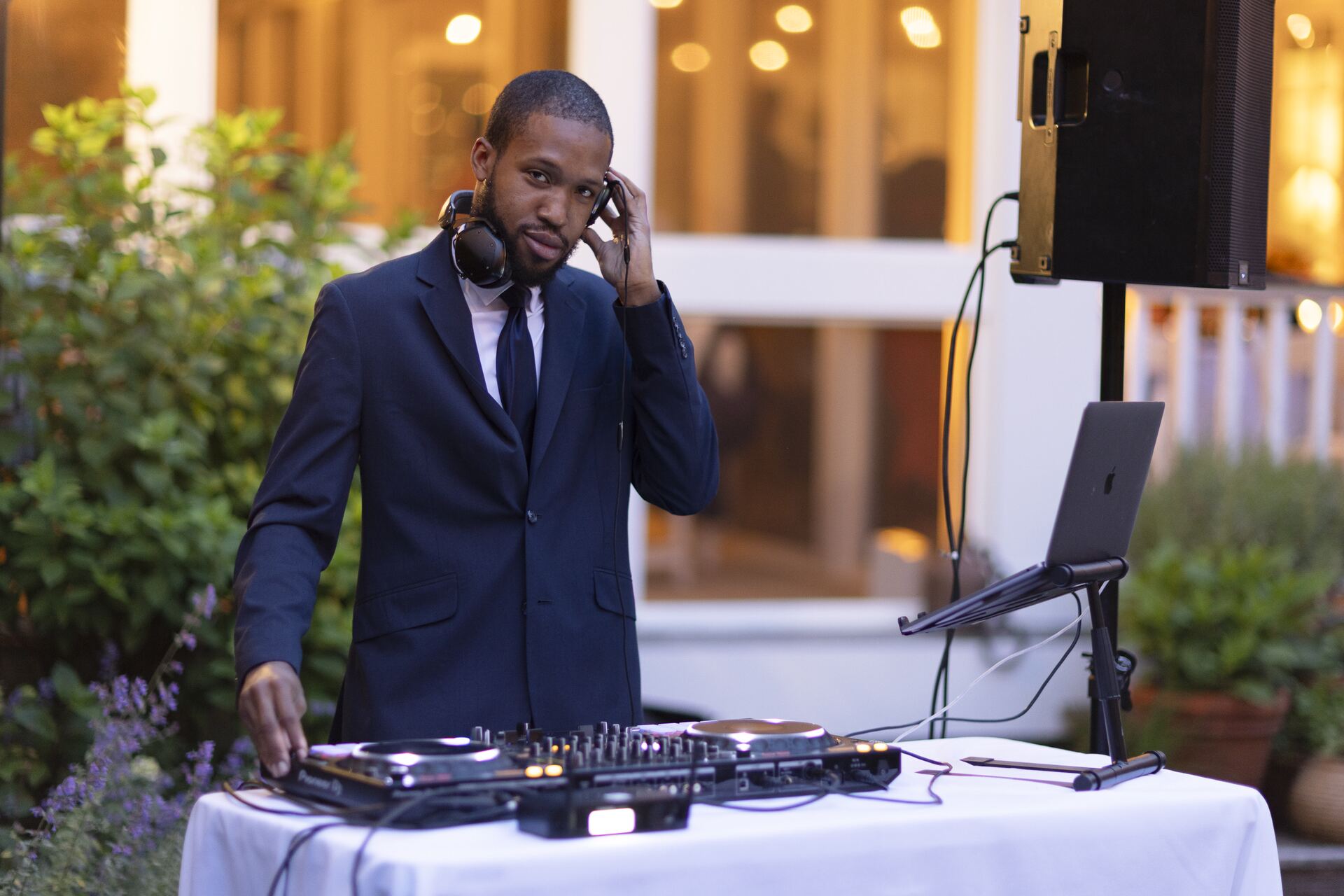 Justin Harmond DJing an outdoor wedding at golden hour