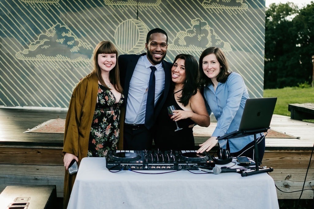 Wedding DJ with guests at an outdoor reception