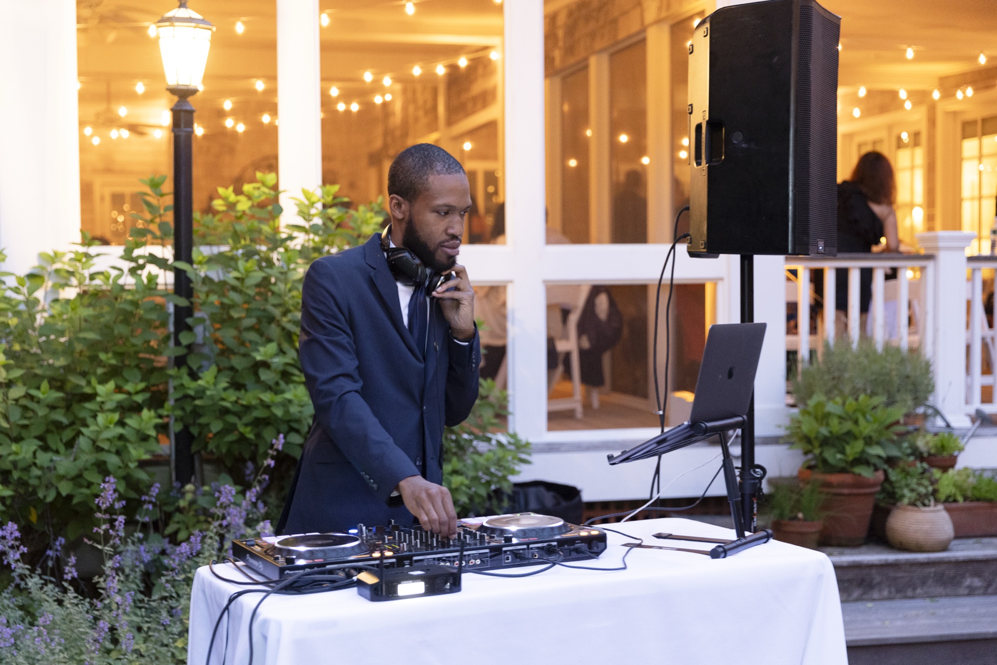 Justin Harmond DJing a wedding under string lights