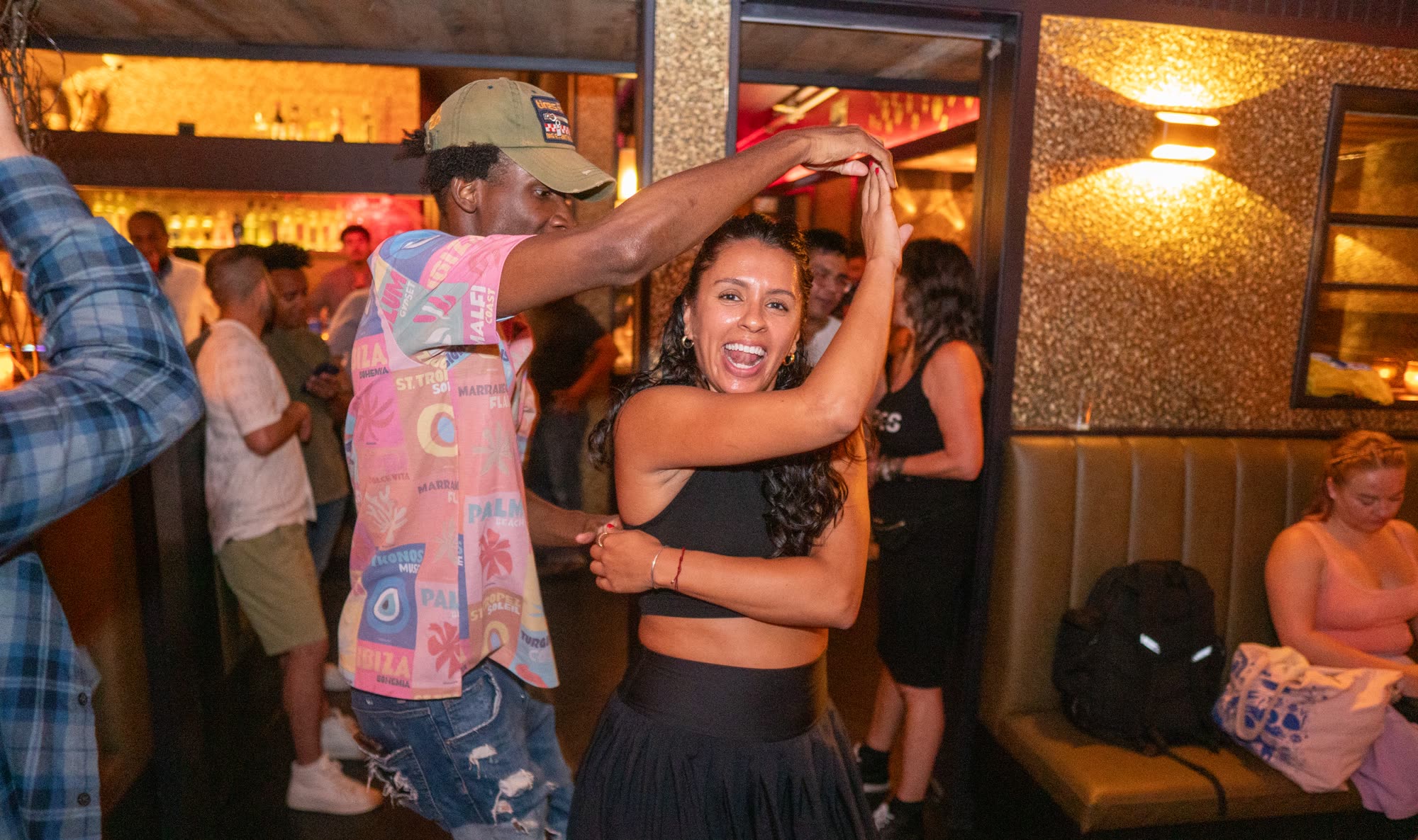 Salsa social dancers laughing mid-spin