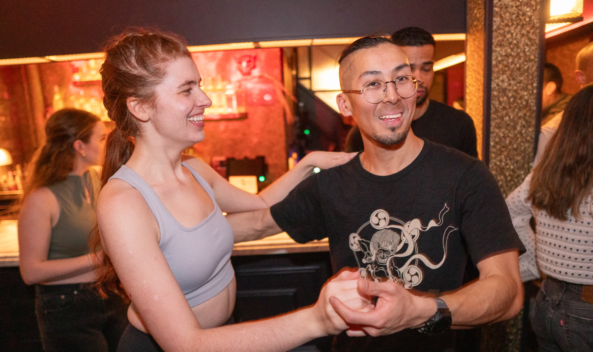 Salsa partners smiling during a lead