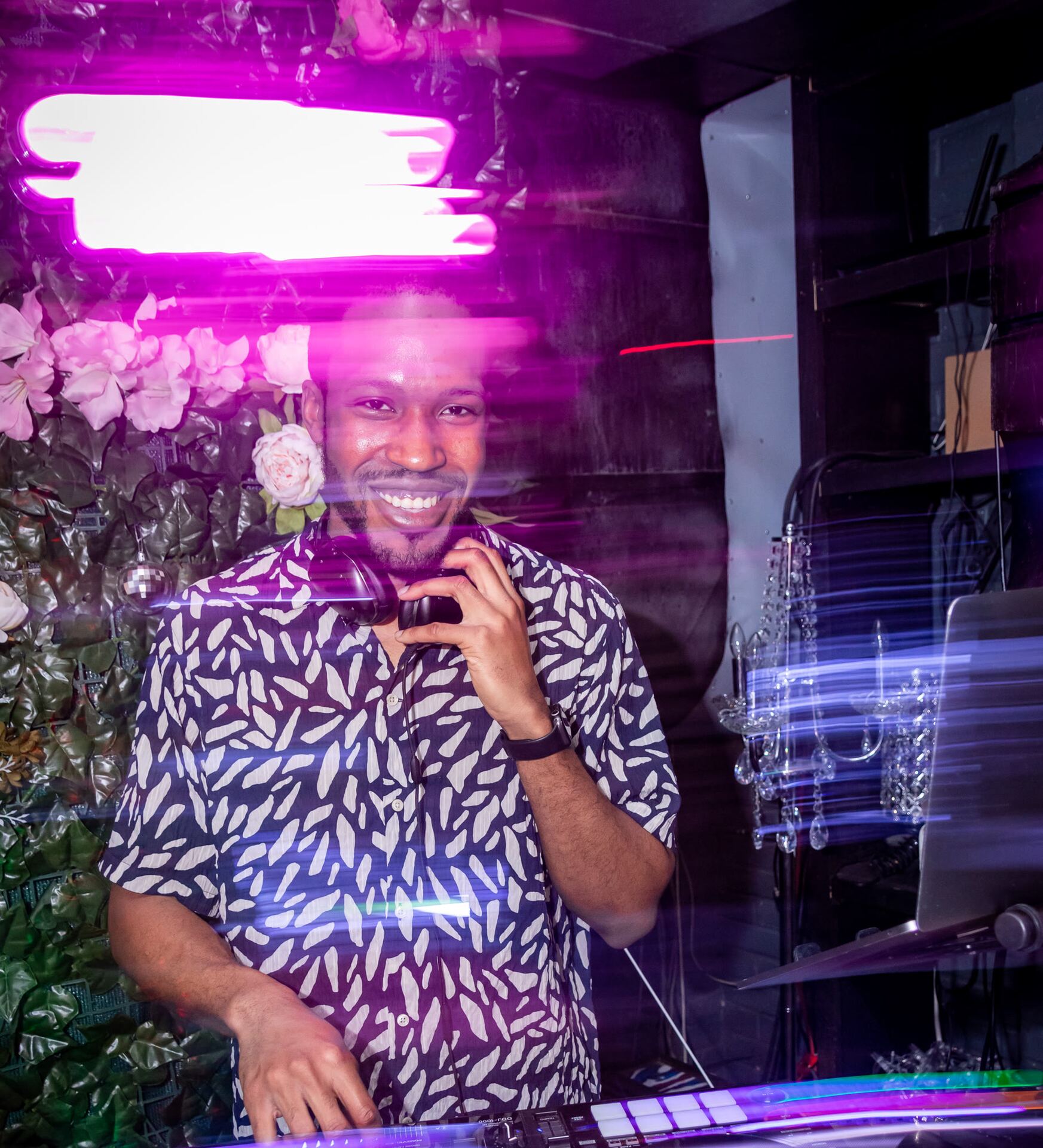 Justin Harmond DJing an NYC event under neon lights