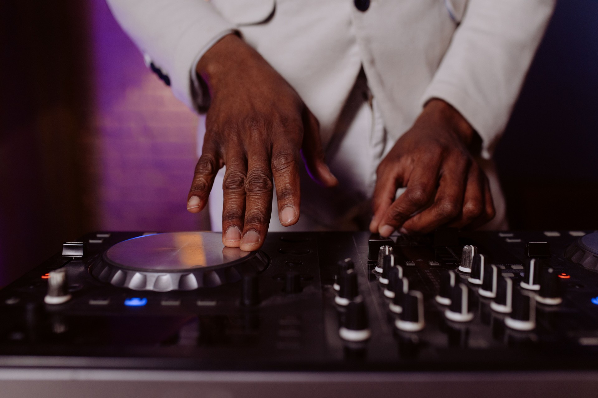 hands control the remote control. setting the remote control knob. electronic device of the mixer console.